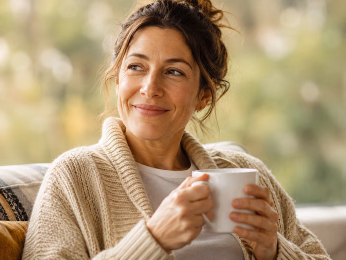 Woman relaxing at home with a cup of coffee